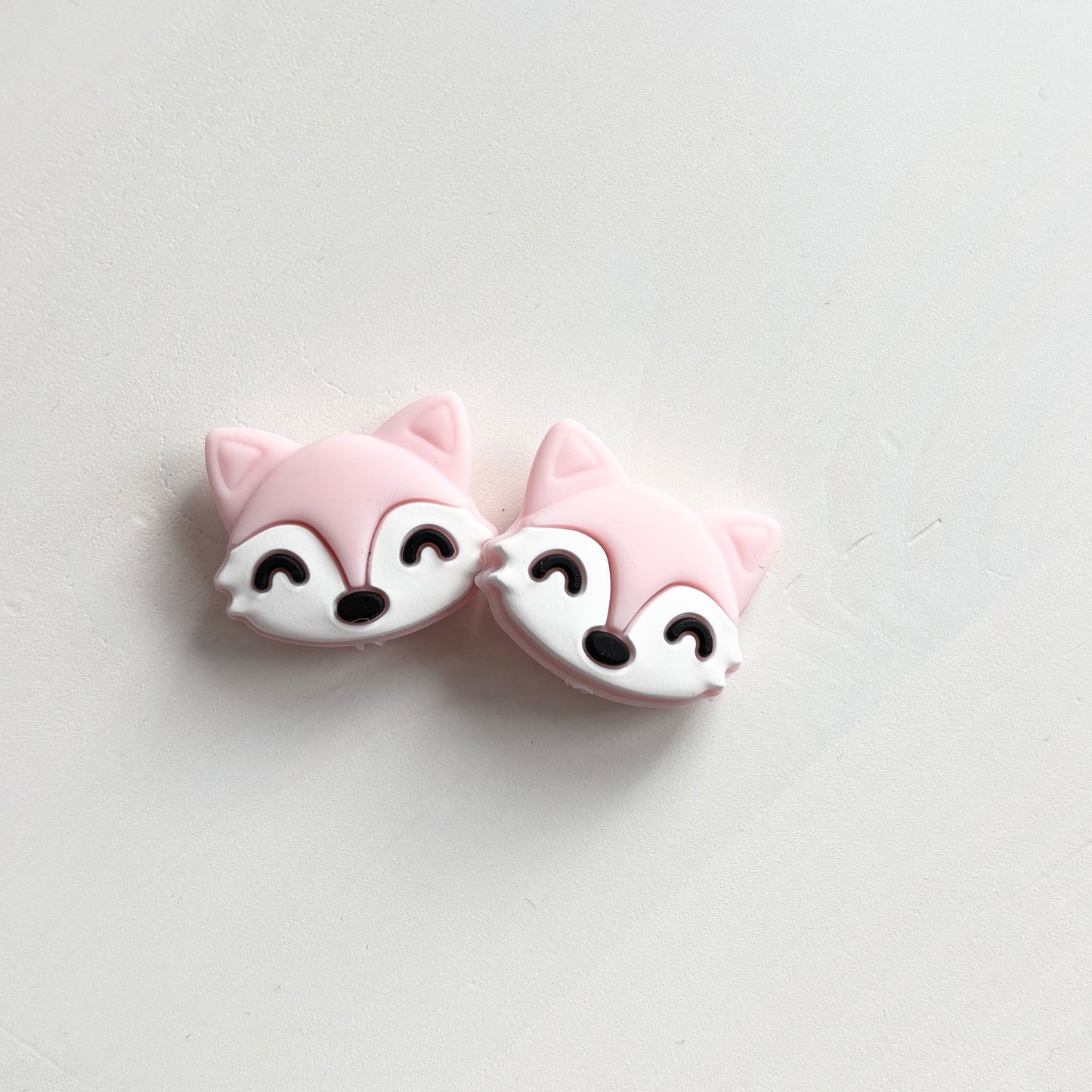 Vaaleanpunaiset kettu puikkostopparit. Auttavat pitämään silmukat puikoilla.