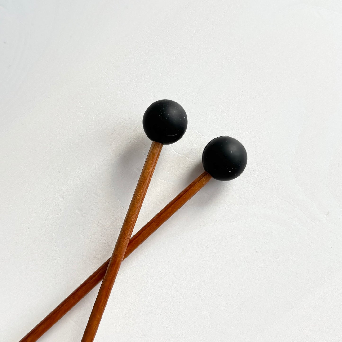 Mustat pallo puikkostopparit. Auttavat pitämään silmukat puikoilla.